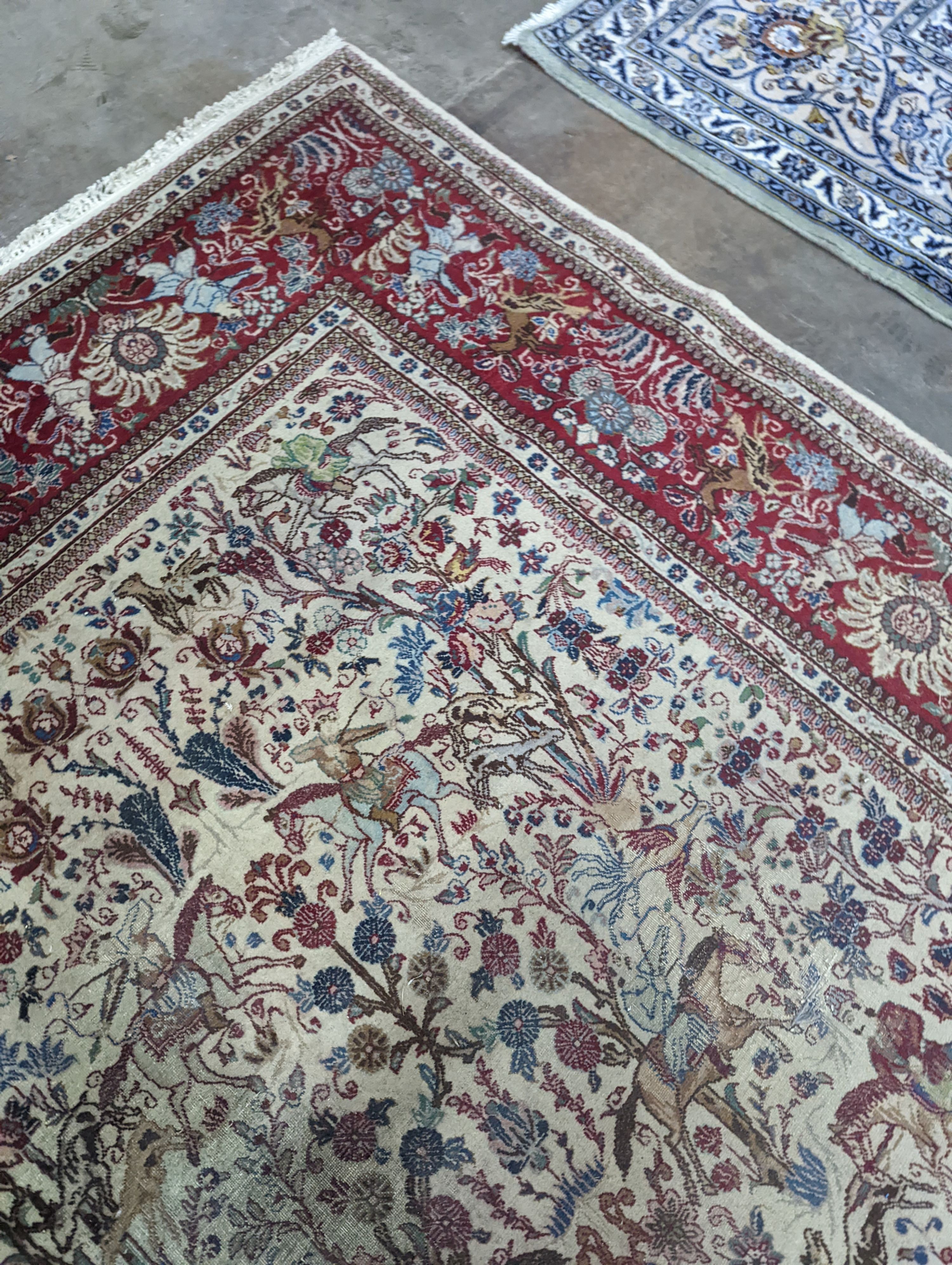 A Tabriz ivory ground pictorial rug (signed), 390 x 294cm